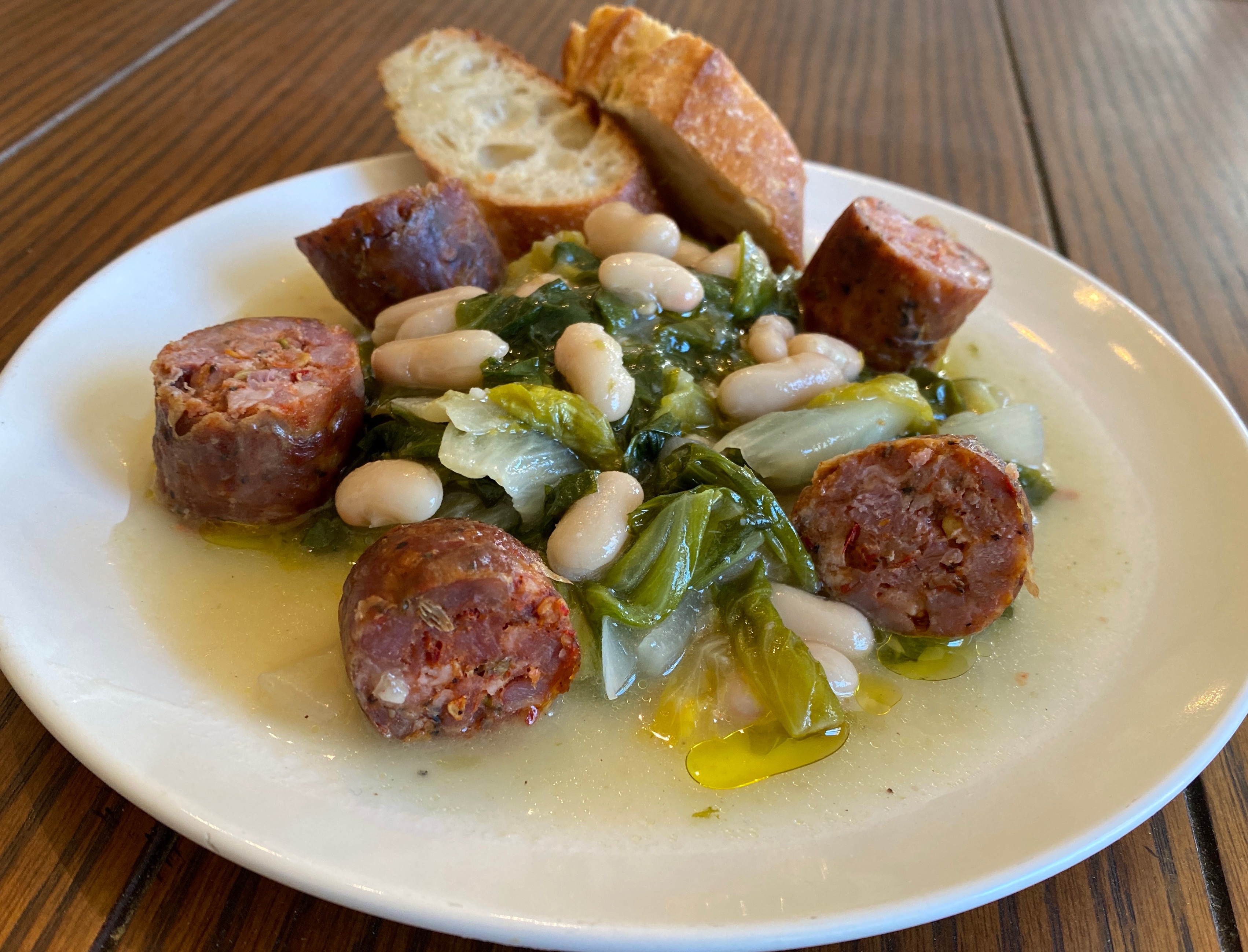A plate with escarole, beans, & sausage